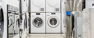 Photo of commercial laundry focused on a washer and dryer